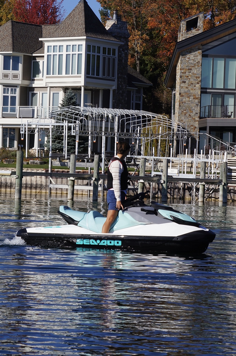 White and turquoise Sea-Doo GTI 130 at the shoreline